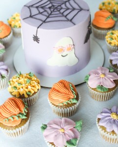 Halloween themed 4" smash cake with buttercream flower and pumpkin mini cupcakes